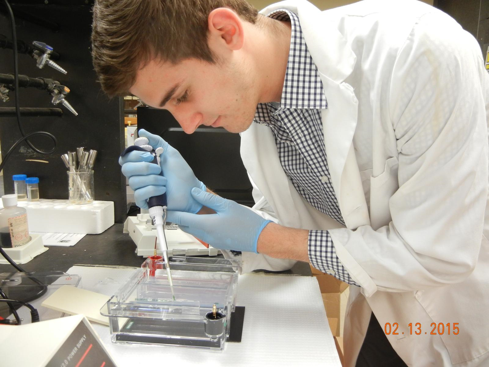 Man using a pipette in a lab