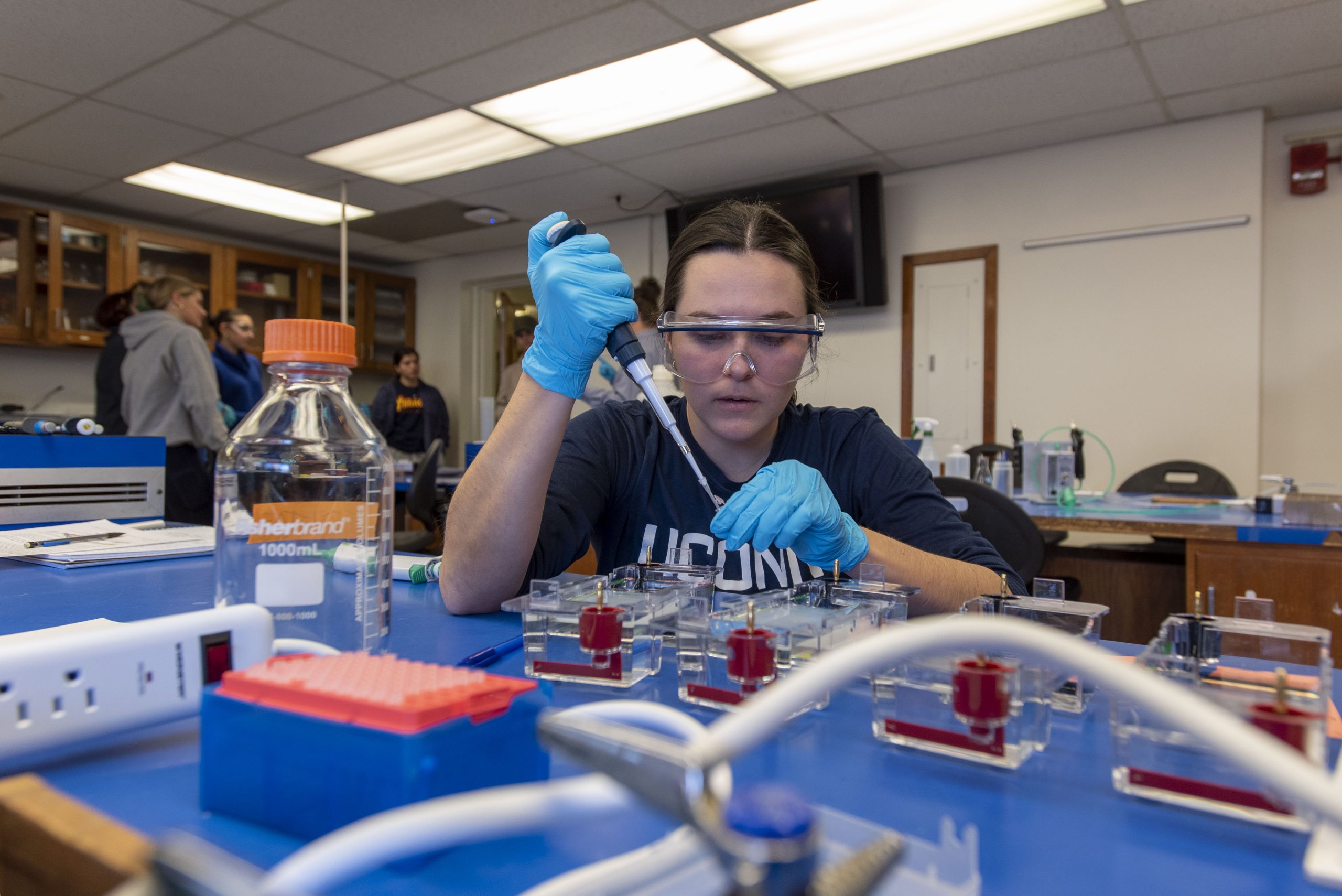 Woman carefully using lab equipment